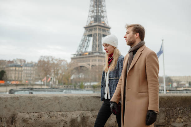 istock Couple walking at Seine River, in front of Eiffel Tower, Paris, holding hands 1372129104