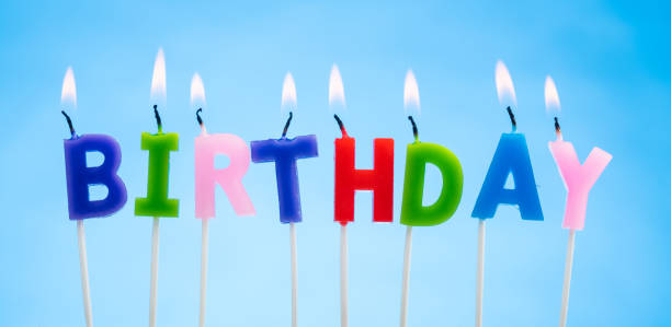 istock Colorful Candles on a  Blue Background that Spell Birthday 1372129137