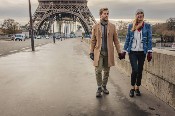 istock Couple walking on Pont d'Iena bridge holding hands, Eiffel Tower, Paris in the background 1372130996