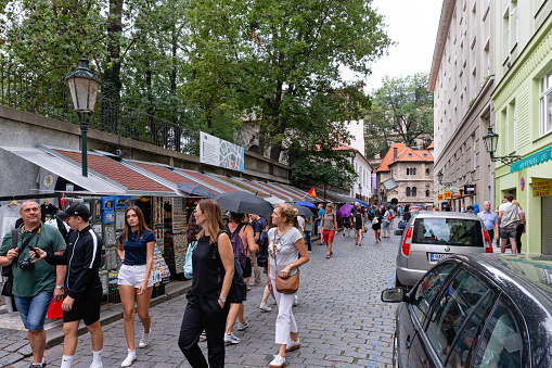 Prague, Bohemia, Czech Republic, august 10th 2018, large group of people (walking, standing, shopping) in the 'U Starého Hřbitova' street in the Jewish part of the old town (known as \