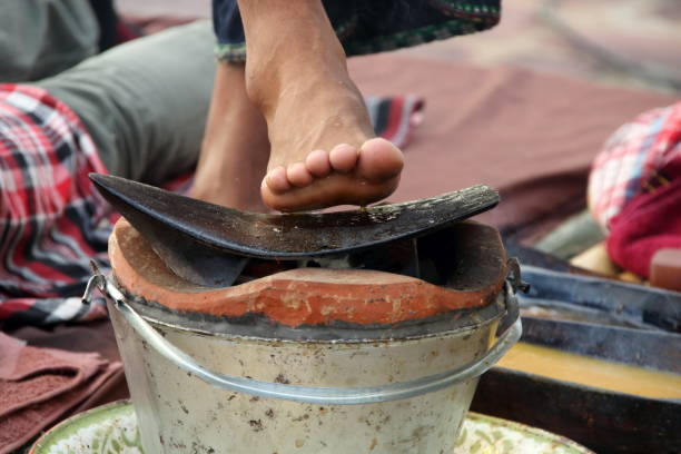 istock Iron plow on clay fire pot and right foot. 1372134061