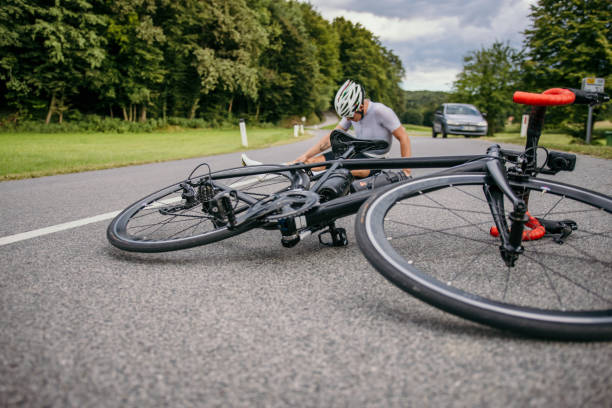 istock Racing bicycle lying in front of injured cyclist 1372135470