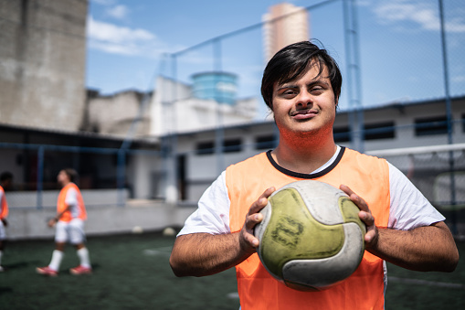 Portrait of a young male soccer player with special needs in a sports court