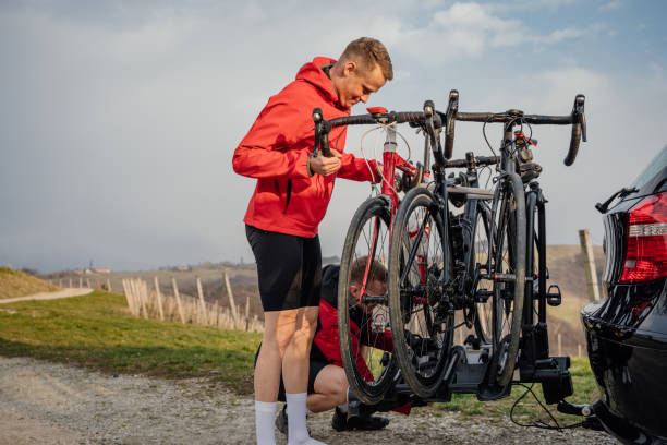 Cyclists attaching bikes on the bicycle rack after training