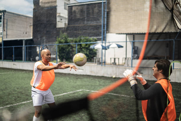 istock Disabled goalkeeper and friend training on the soccer field 1372135959