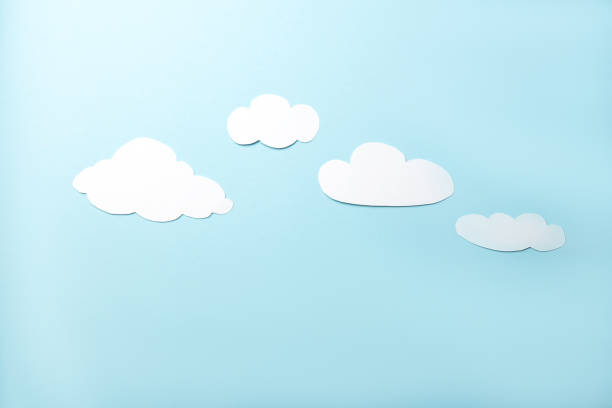 istock Paper art. White clouds on a bright blue background 1372136844