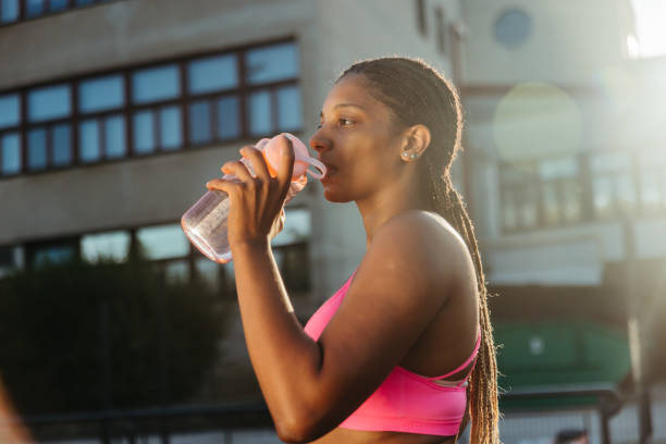 istock Woman athlete drinking water from the bottle 1372137236