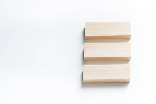 istock Three wooden toy cubes arranged in row on white background 1372137416