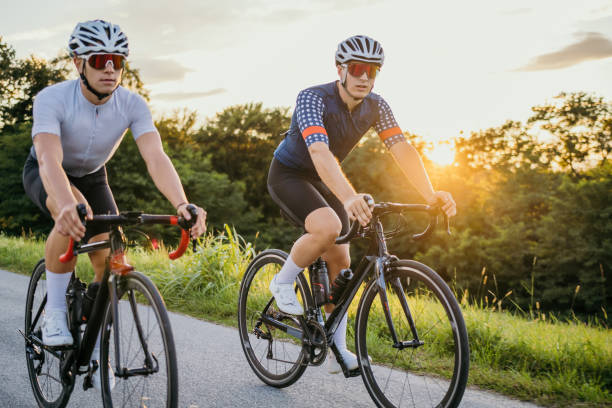 istock Professional cyclists riding bikes at sunset 1372138322