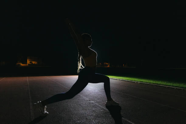 istock Female athlete stretching before the evening training session 1372138326