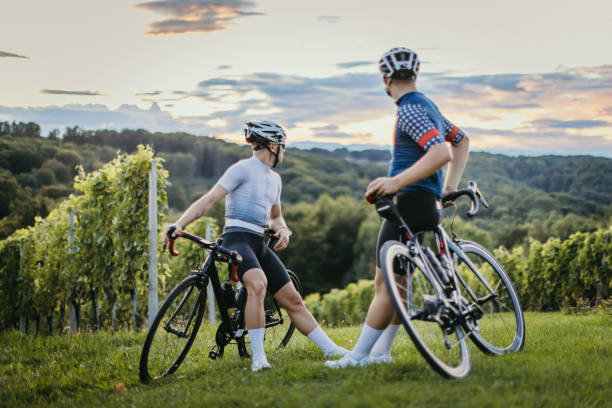 istock Cycling teammates relaxing by the vineyard at sunset 1372138470