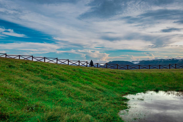 mountain top view with bright sky and its reflection on water at morning from different angle image is taken at latilum peak shillong meghalaya india.