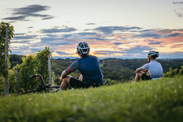 istock Cyclists drinking and enjoying the view in the vineyard at sunset 1372138886