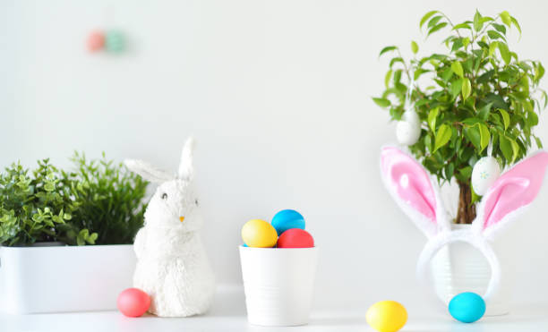 istock Colored eggs, cute little bunny and rabbit ears on the table on Easter day. Celebrating Easter at spring. Painting eggs. 1372144736