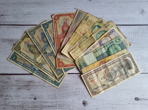Old Brazil banknotes, out of circulation, obsolete, on a wooden table, top view.