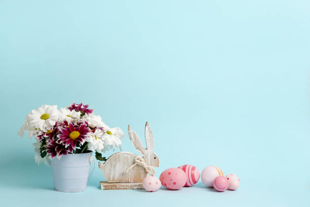 istock Happy Easter. Congratulatory easter background with wooden bunny, eggs and flowers. copy space 1372145094