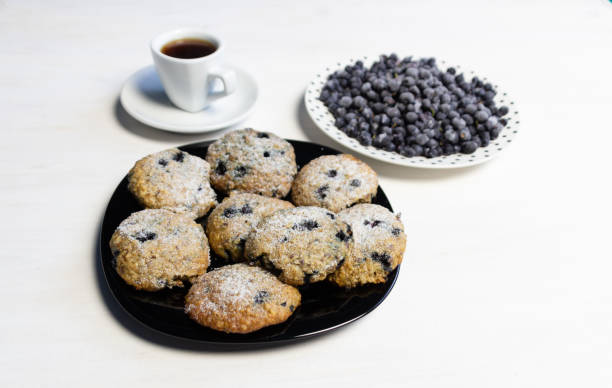 istock cup of coffee and blueberry cookies on white table 1372146521