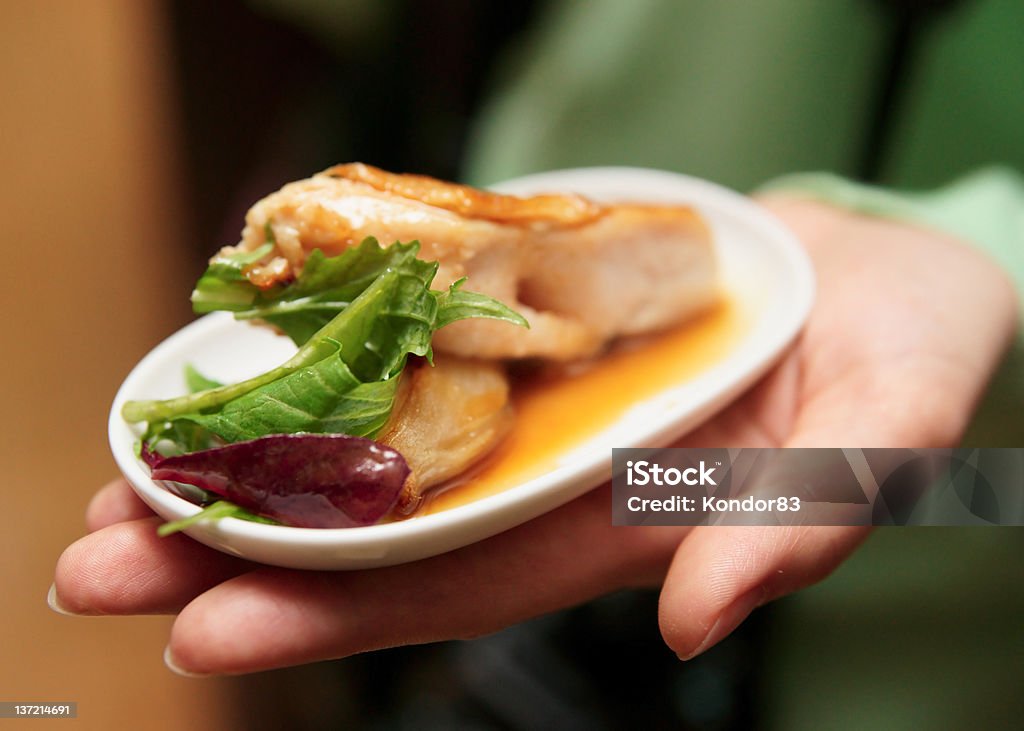 Woman offering snack Woman offering small snack on banquet Small Stock Photo