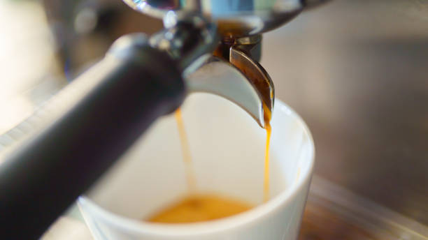 istock espresso coffee is pouring from the coffee machine into a white cup 1372147417