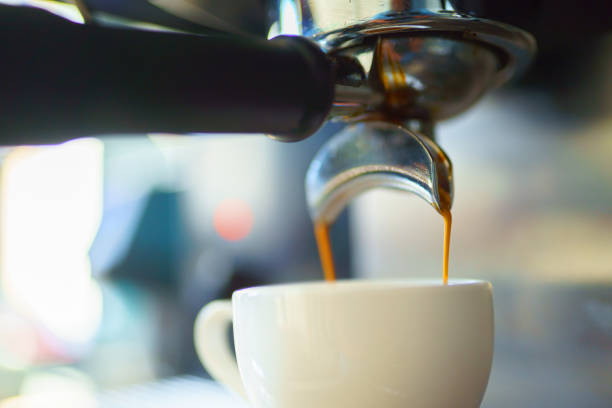 istock espresso coffee is pouring from the coffee machine into a white cup 1372147746