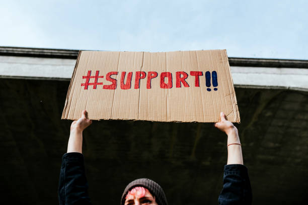 istock Unrecognizable person holding a cardboard sign 1372149615