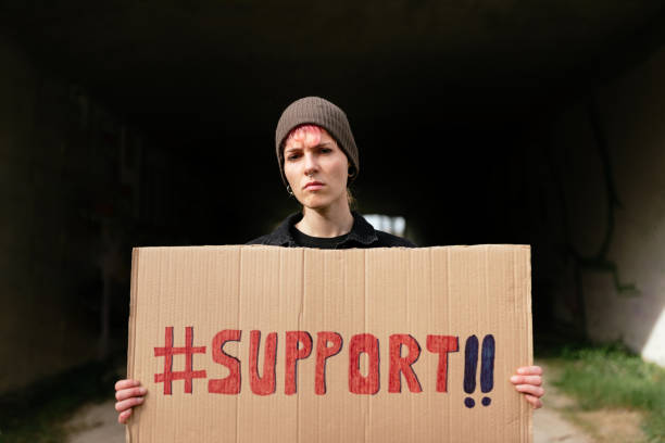 istock person holding a cardboard sign 1372149704