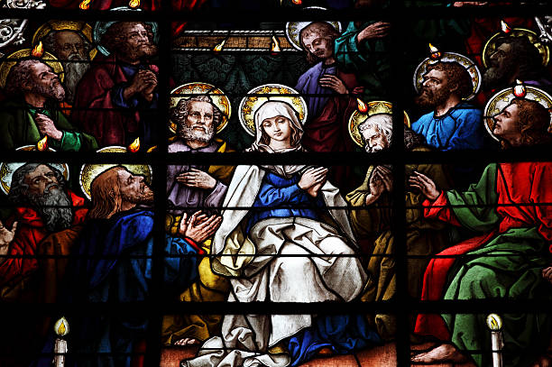 Stained Glass showing pentecost scene Stained Glass showing pentecost scene from the SXV-XVI from la Giralda, the Cathedral of Seville, the biggest Gothic Church of the World and fourth  largest chirstian church in the world, named by UNESCO World Heritage site. pentecost religious celebration photos stock pictures, royalty-free photos & images