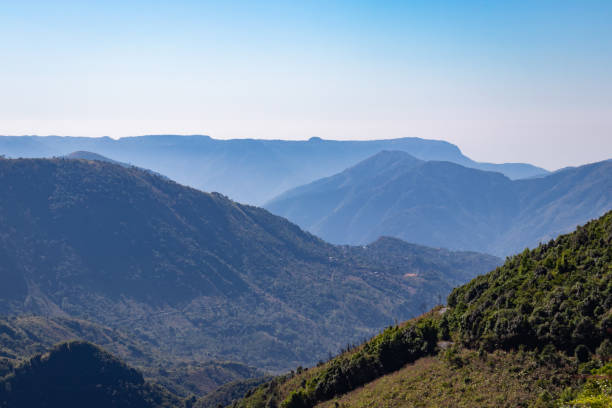 istock misty mountain range covered with forests and bright blue sky at morning 1372151030