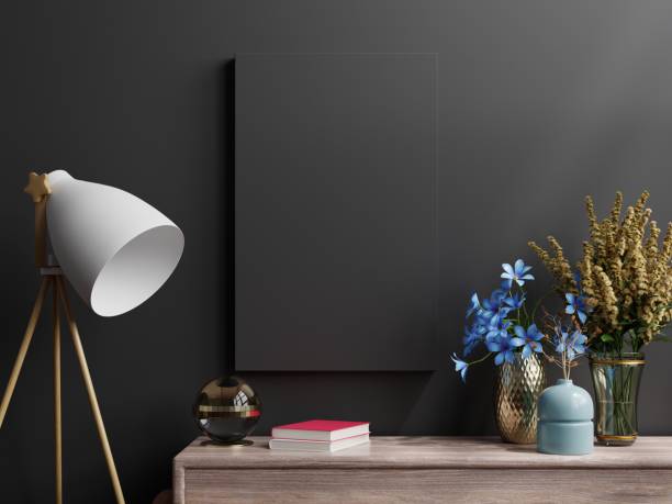istock Mockup black frame on cabinet in living room interior on empty dark wall background. 1372153371