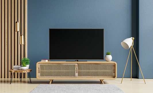 TV and Cabinet in modern living room on blue concrete wall background,3d rendering