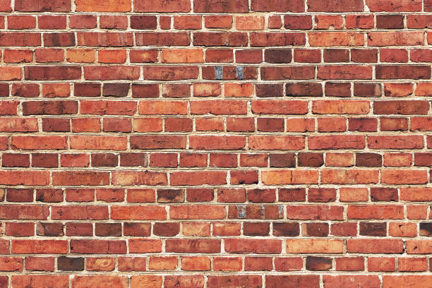 istock Fragment of an old red brick wall. Grunge textured background. 1372154618