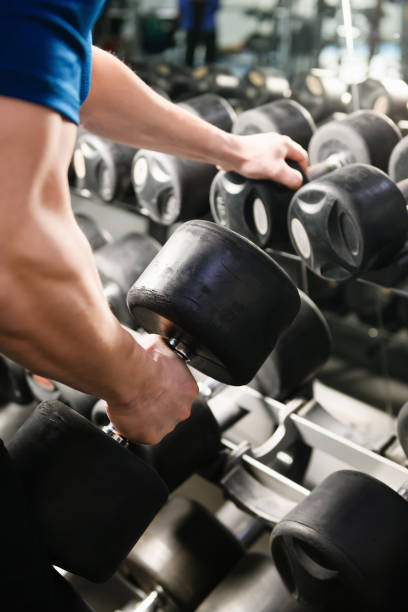 istock Strong male hand hold heavy gym weight 1372155120