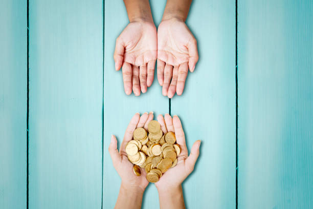 istock Close up of unknown hands giving donation 1372155144