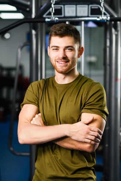 istock Sportive fit man portrait in gym interior 1372155183