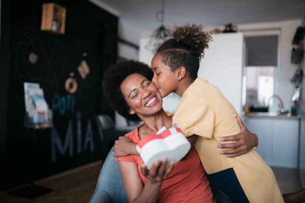 African American mother and daughter celebrating mother's day at home