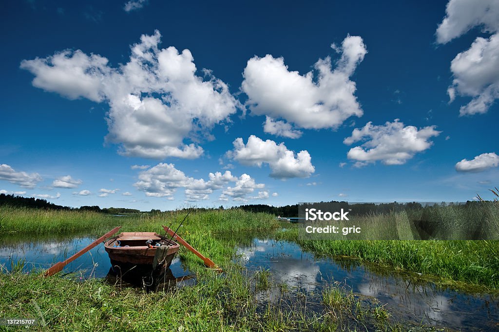 Lake with fisherman boat Lake in Latvia Backgrounds Stock Photo