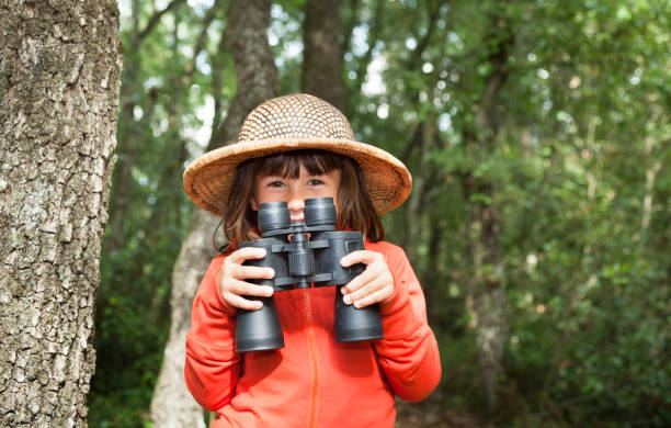 istock Happy little girl exploring through binoculars 1372157934