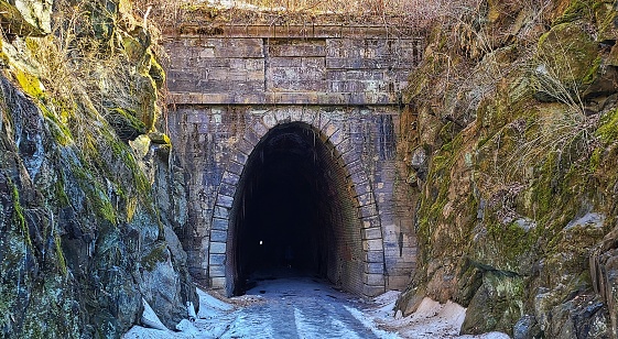 Blue ridge tunnel, long and dark, Historic train tunnel with snow and ice.