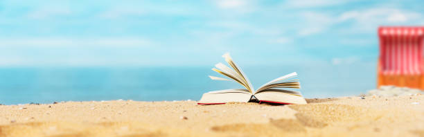 istock Book on the beach with sea in the background 1372158712