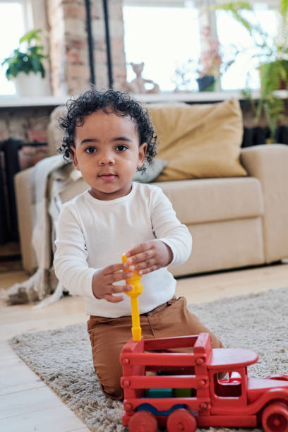 istock Mixed race boy repairing toy car 1372158787