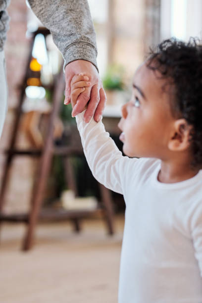 istock Holding mothers hand 1372158813