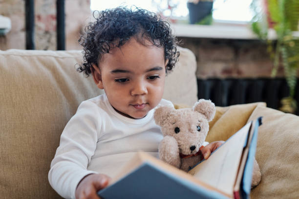 istock Reading book to toy bear 1372158844
