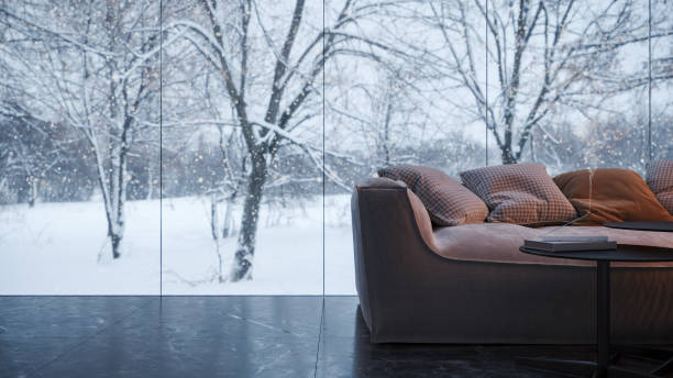 istock Modern interior design with sofa and window looking at beautiful winter landscape 1372158972