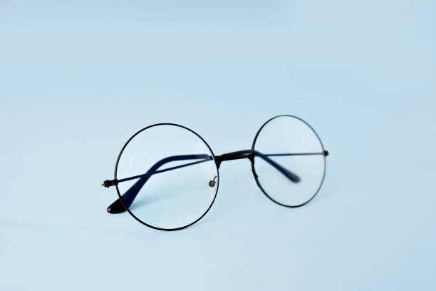 istock Round eyeglasses for vision on a blue background with space for text 1372160534