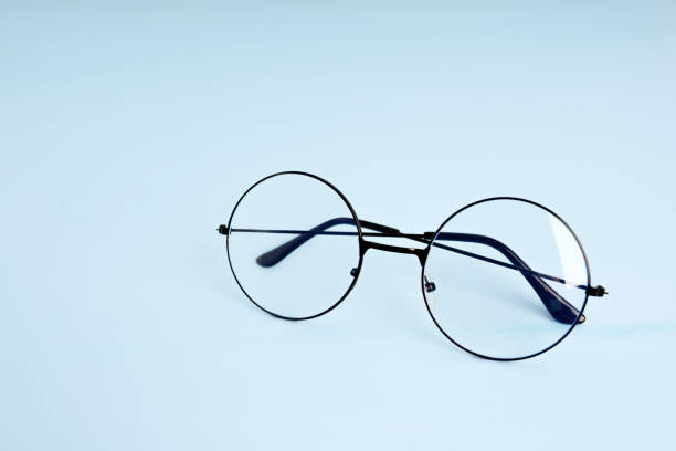 istock Round eyeglasses for vision on a blue background with space for text 1372160543