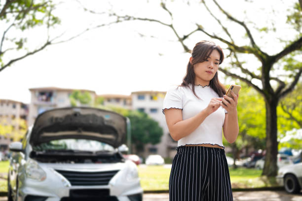 istock Asian woman calling for roadside assistance 1372160907