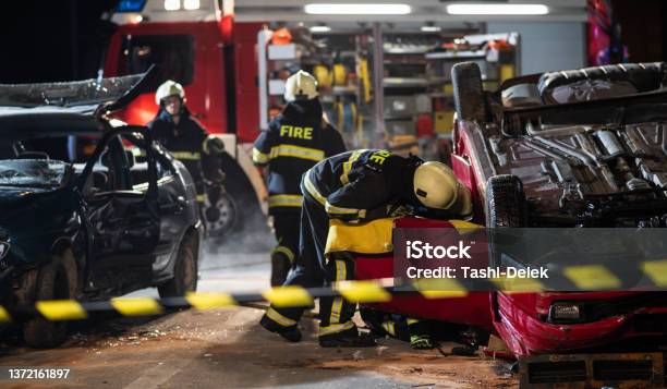 Firefighters At A Car Accident Scene Stock Photo - Download Image Now - Car Accident, City, Crash