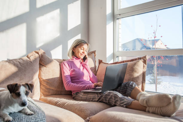 istock Attractive middle aged domestic lady sitting comfy sofa couch 1372162360