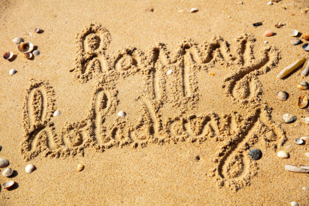 istock happy holidays writing on the beach 1372163646