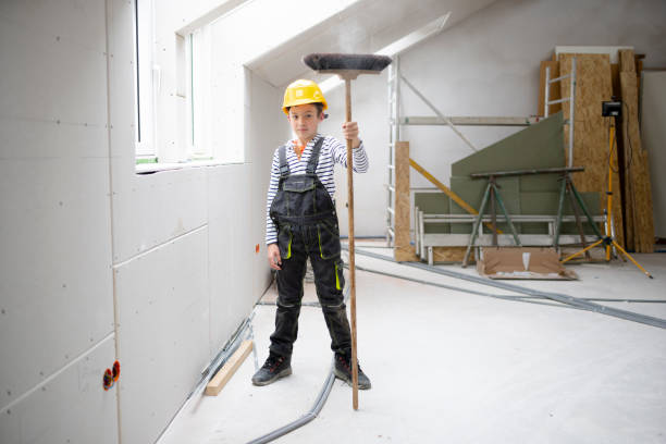 istock cool boy with yellow helmet on construction site with broom 1372164532